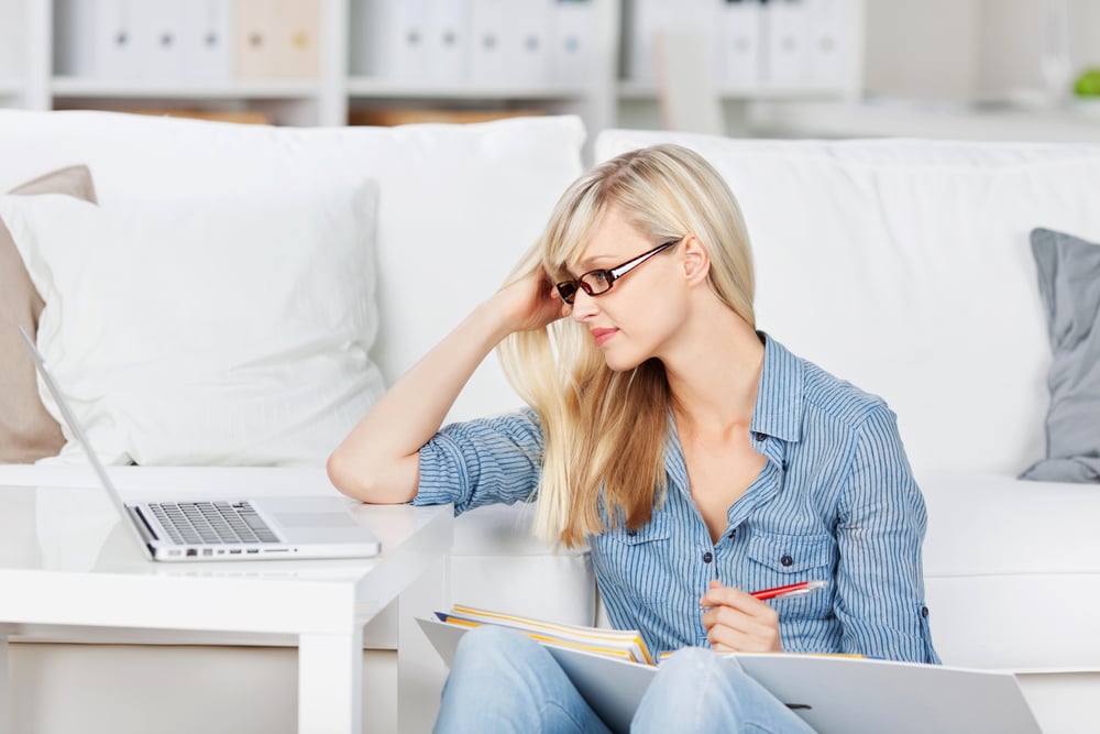 Beautiful woman reviewing her lesson with her laptop and book