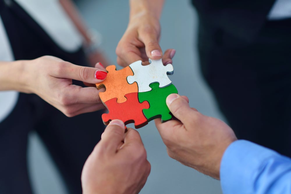 Group of business people assembling jigsaw puzzle and represent team support and help concept Group of business people assembling jigsaw puzzle and represent team support and help concept