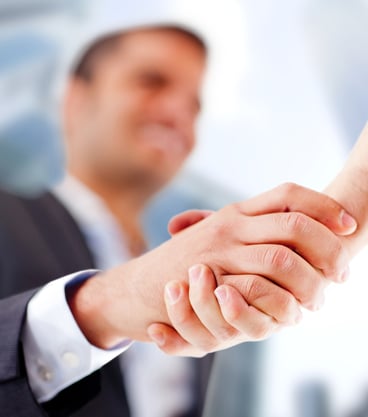 Business man closing a deal with a handshake