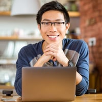 Portrait of positive asian male in glasses with laptop in cafe-1