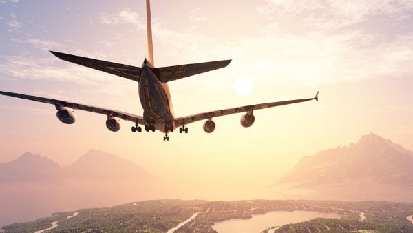 A plane flying over a landscape