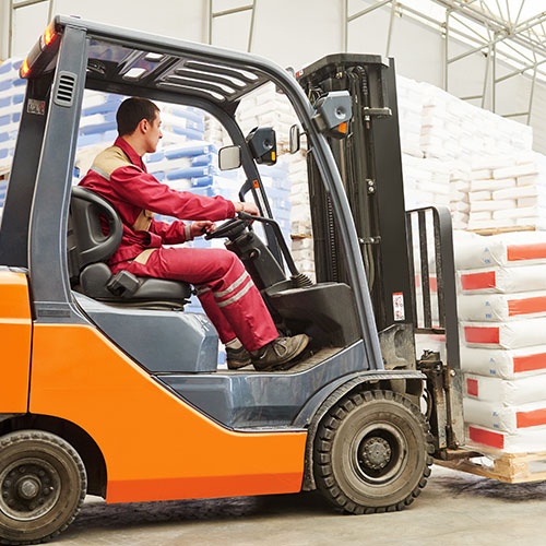 An image of a forklift carrying a pallet of goods