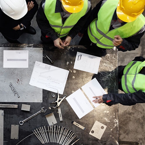 An image of workers gathering around a table