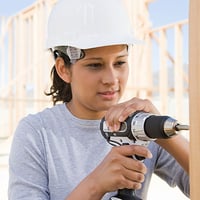 An image of a woman constructing a house