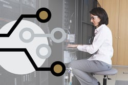 An IT worker in a server room An IT worker in a server room